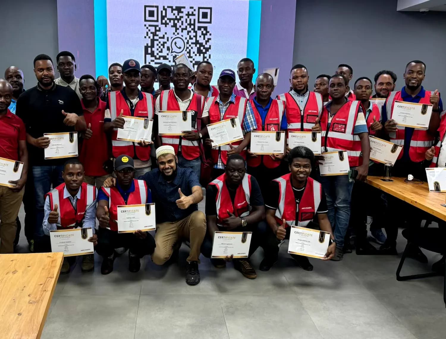 Technicians holding their certificates at the end of a Pentagon Solutions training workshop.